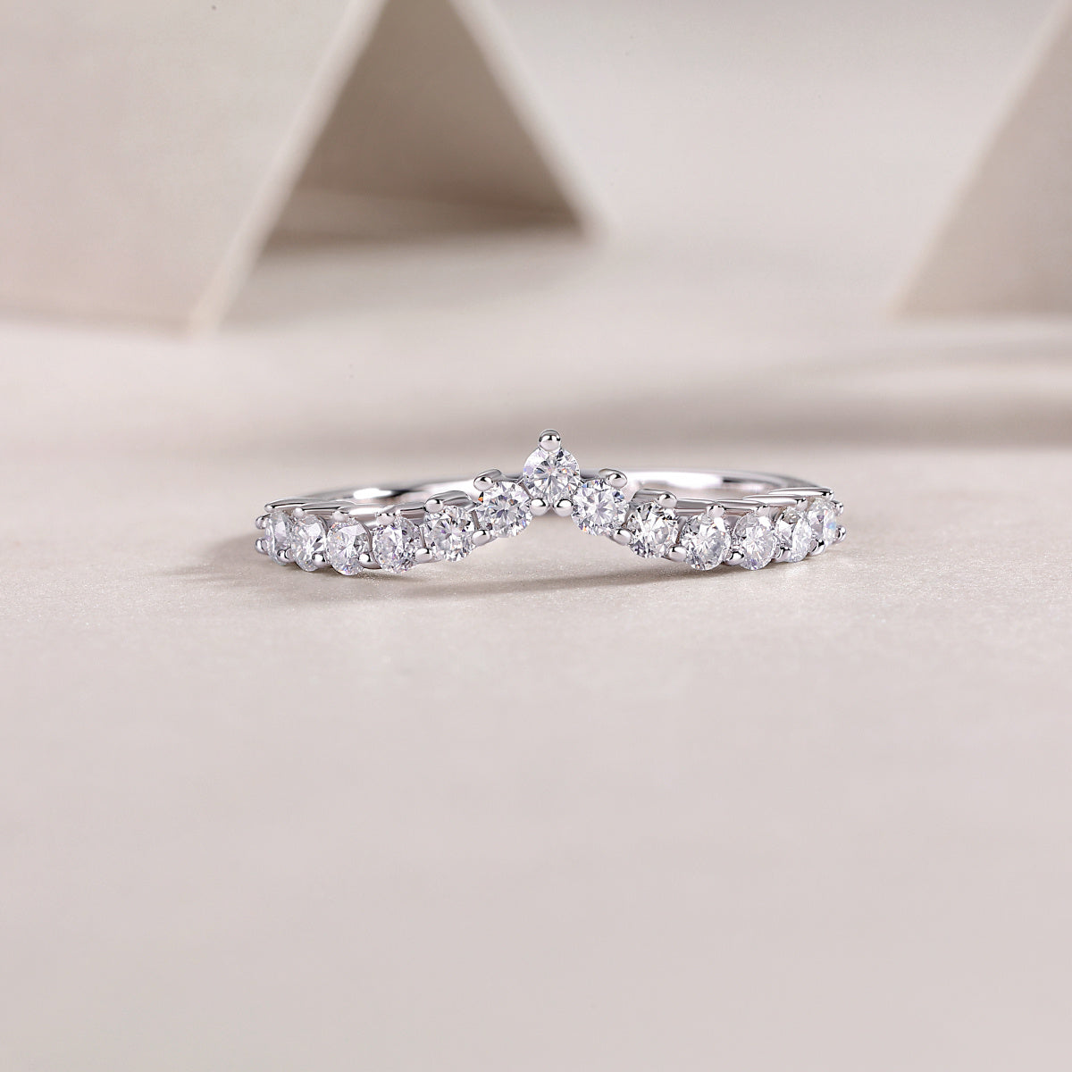V-curve wedding band moissanite stones close-up
